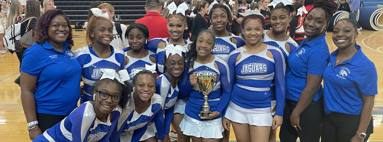 Competition cheer squad girls with award trophy