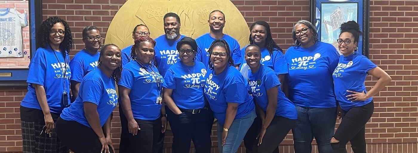 Math Department on March 14th, wearing royal blue PI shirts. 